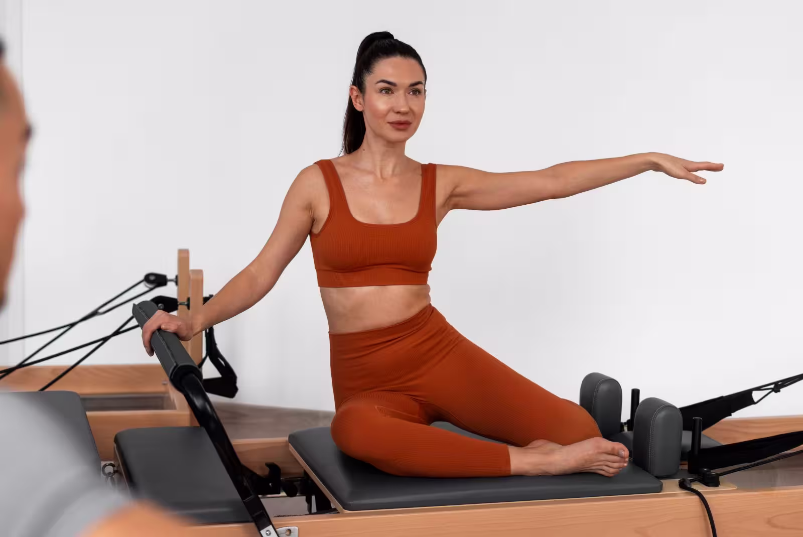 Full Body Control Mastering the Pilates Reformer in Spain Woman achieving full body control on Reformer; reflects Pilates mastery, precision, and elite wellness status in Spain.