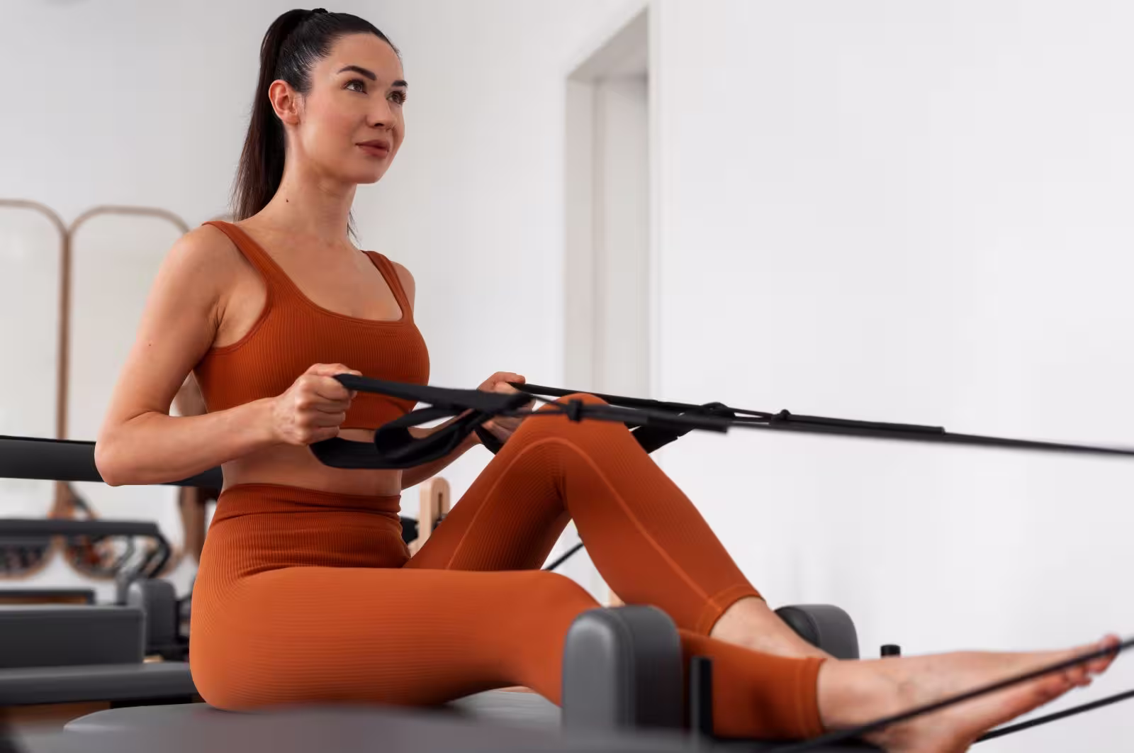 Reformer Pilates The Core Discipline for Executive Wellness Person on Reformer; reflects core discipline, executive wellness, and physical mastery status in modern fitness.