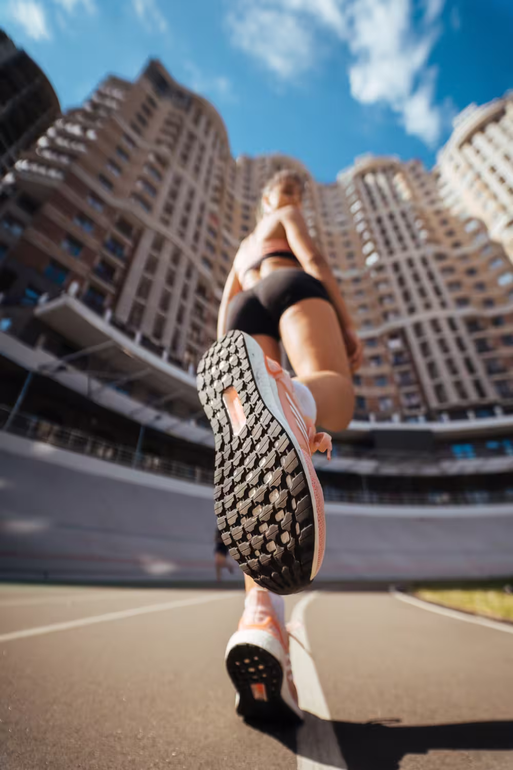 Woman jogging in city; reflects body control, resistance to burnout, and modern status.