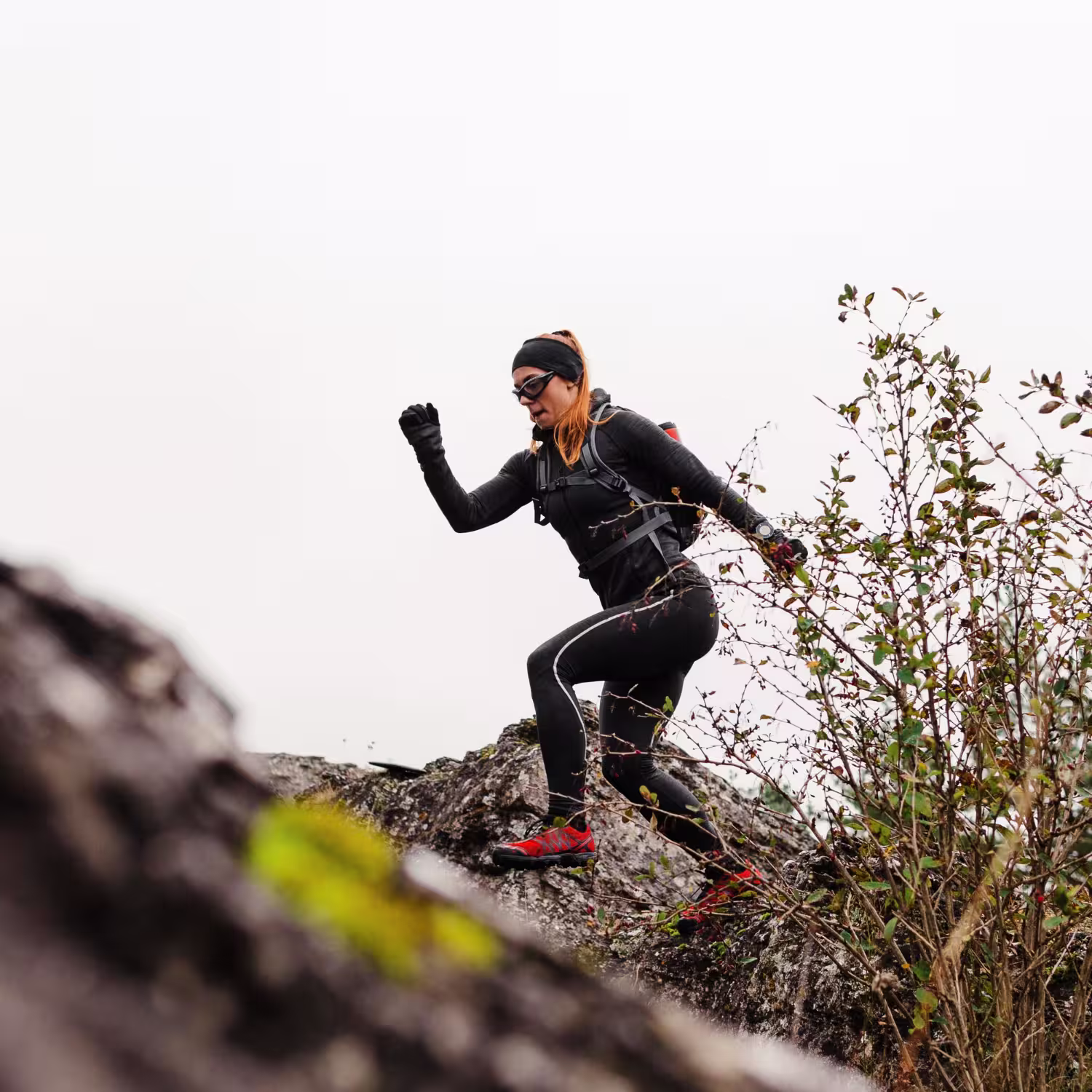 Runner ascending rocky mountain; reflects extreme discipline, resistance, and self-mastery status.